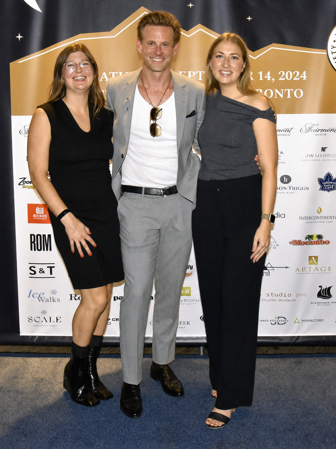 Eric with two smiling guests at Jasper Benefit Night in September 2024