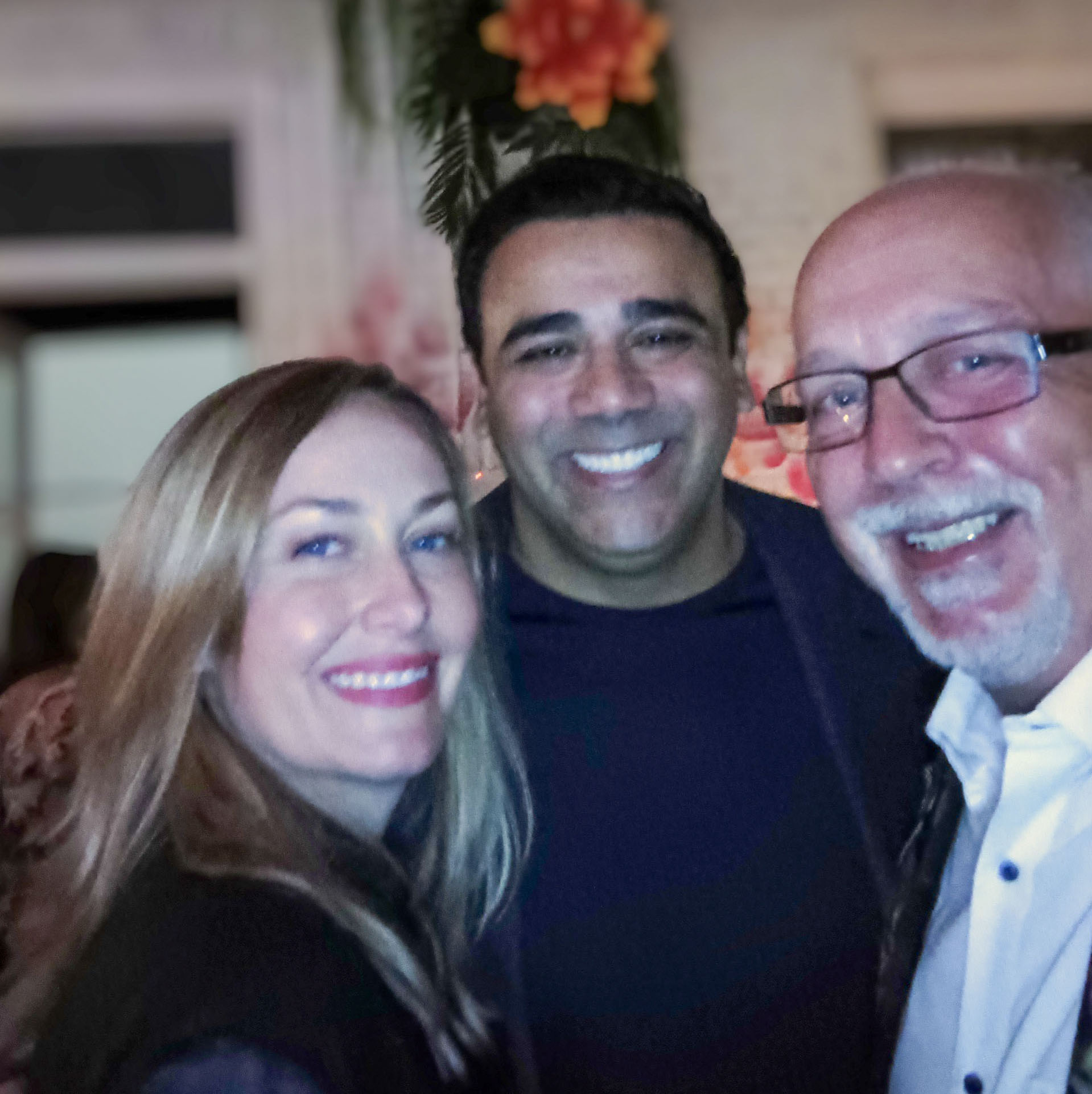 Three guests together at an evening gathering