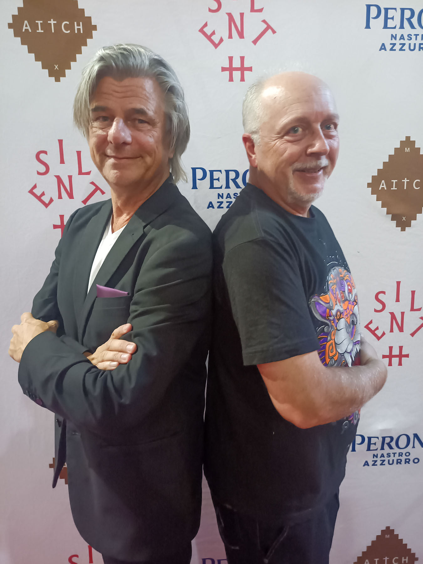Two guests at a 2025 step-and-repeat