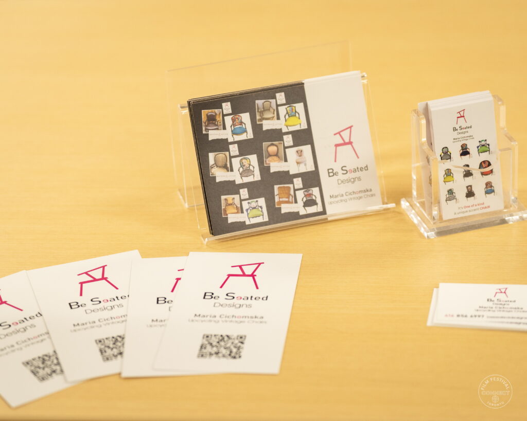 Be Seated Designs brochures and business cards displayed on a table at the AI & Film Forum.