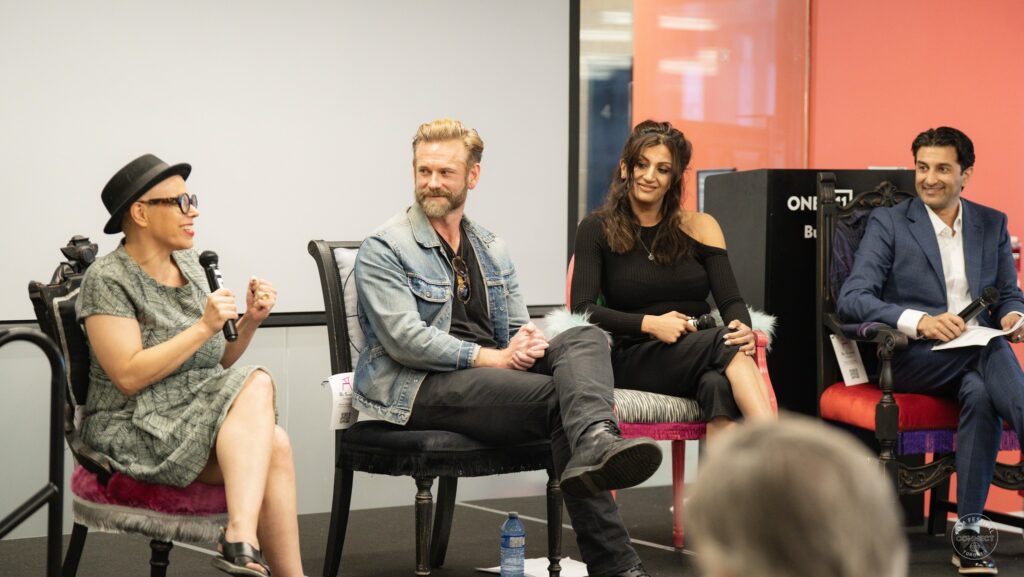 The four participants share an animated moment, with the speaker on the left gesturing and the others smiling. AI & Film Forum, Panel 1, September 14, 2026.
